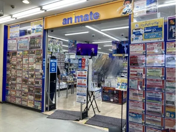 Animate Kyoto store entrance with bright posters and shelves stocked with anime merchandise in Kyoto's anime district