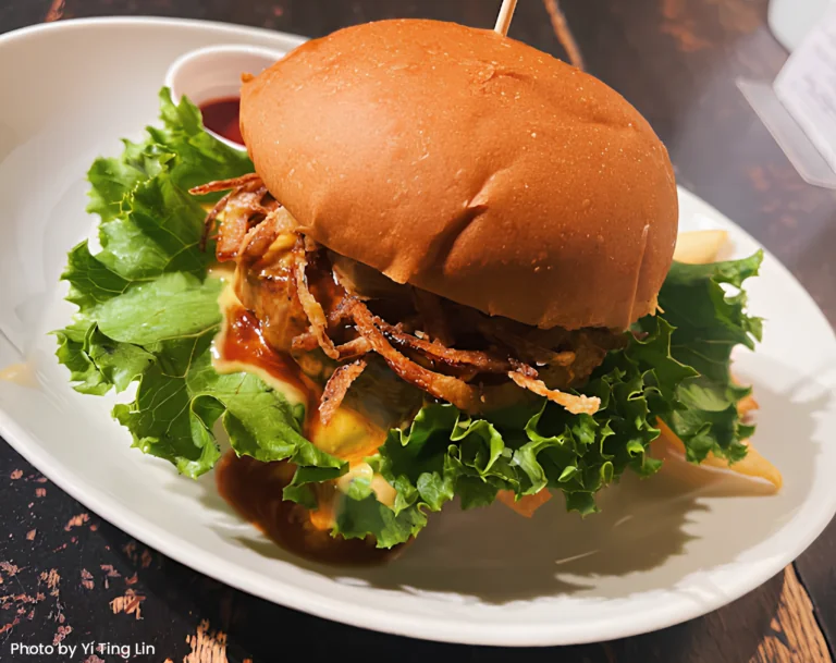 A hearty vegan burger with fresh lettuce, crispy onion rings, and plant-based patties, a delicious option in Kyoto