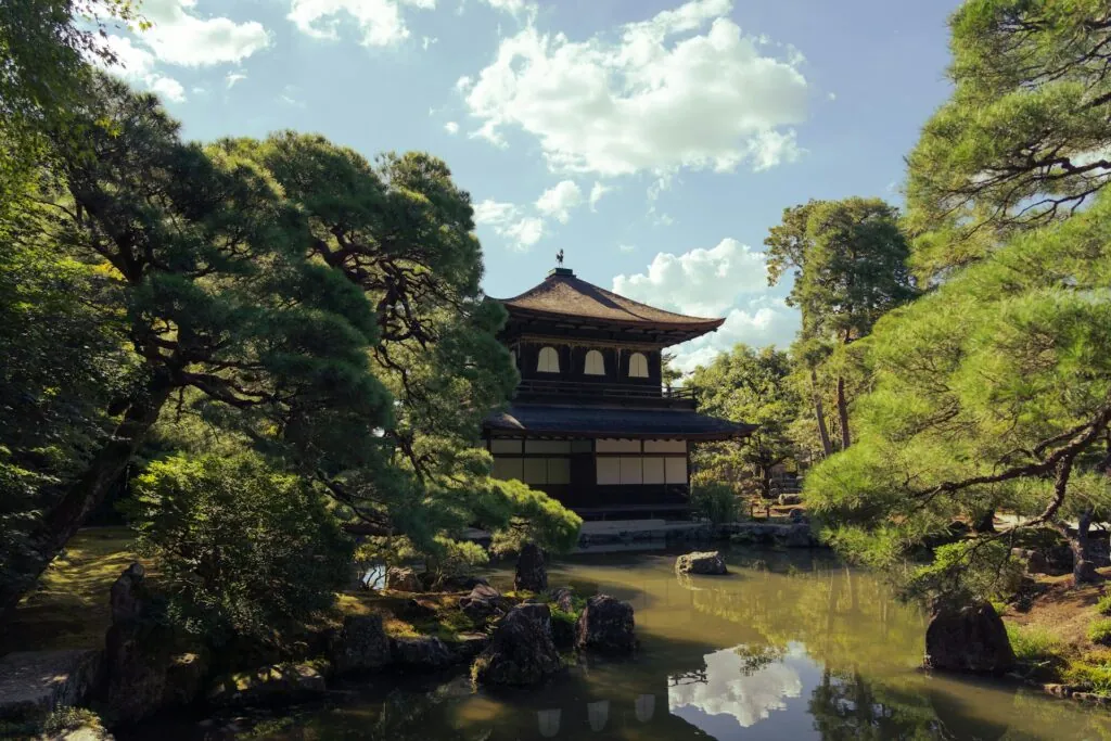 Ginkaku-ji Temple, surrounded by lush greenery and a reflective pond, featured on Kyoto free walking tours