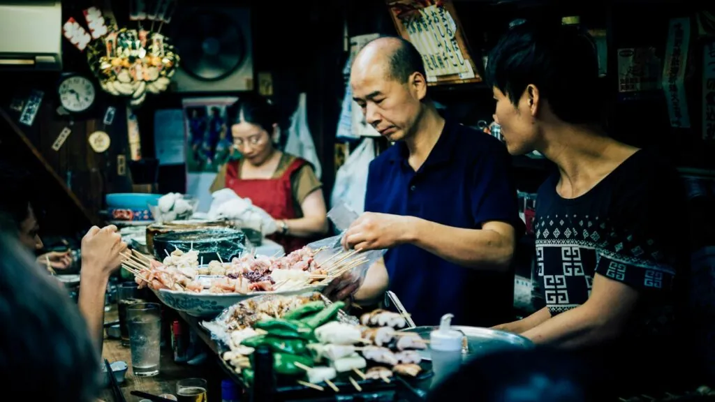 Visitors browsing traditional snacks and goods at Nishiki Market, a vibrant stop on Kyoto free walking tours